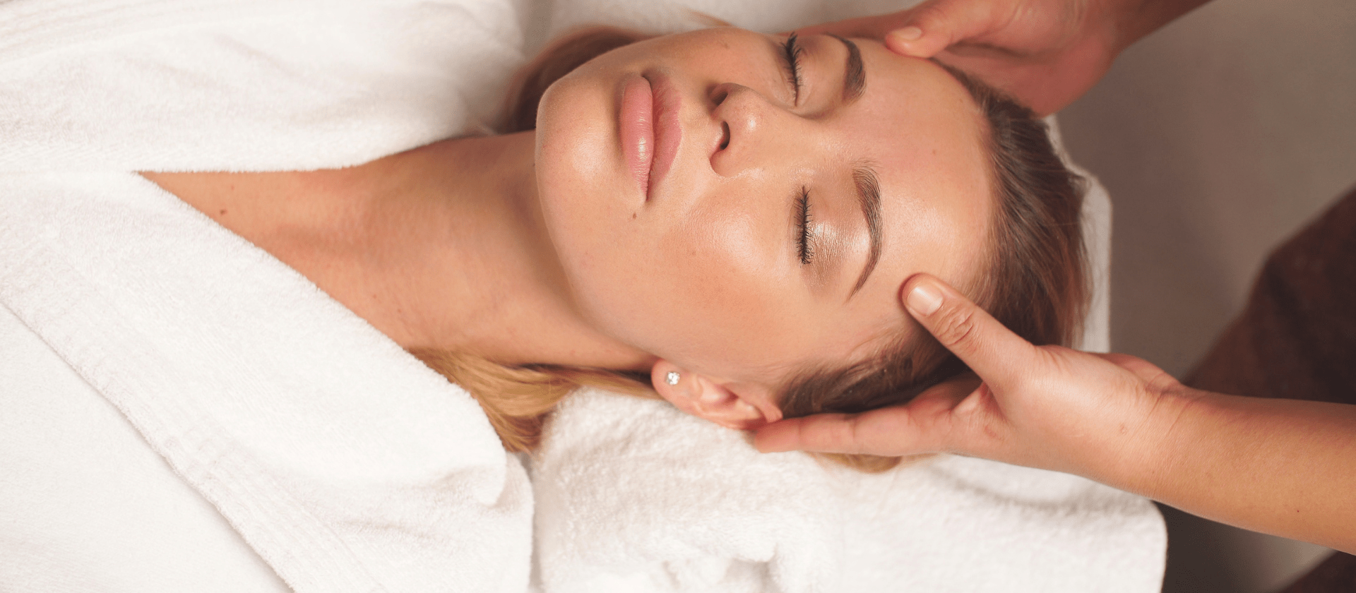 woman relaxed on table getting facial treatment