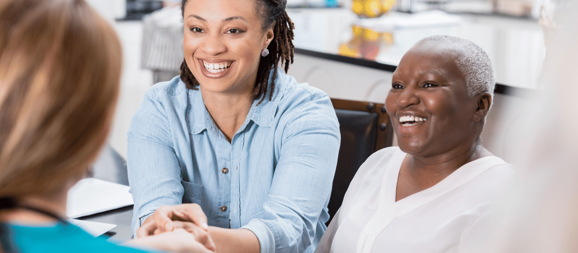 A woman and her mother in a surgical dermatology consultation meeting.